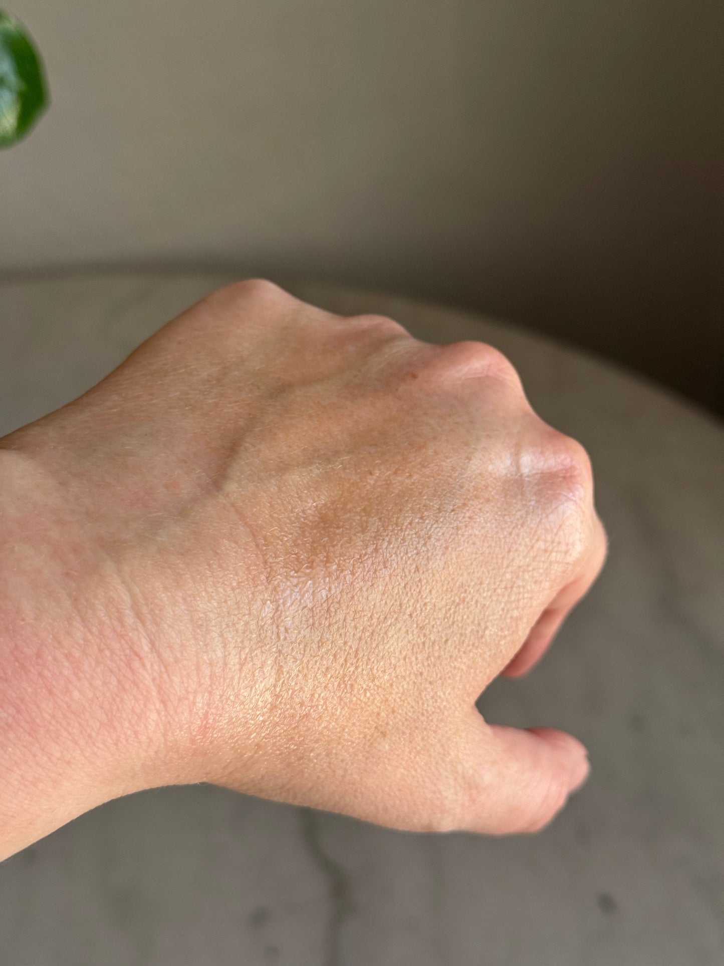 Close up of a hand with Base Layer product on it with a blurred background