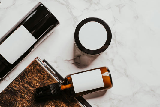 unlabeled skincare products against a white marble surface