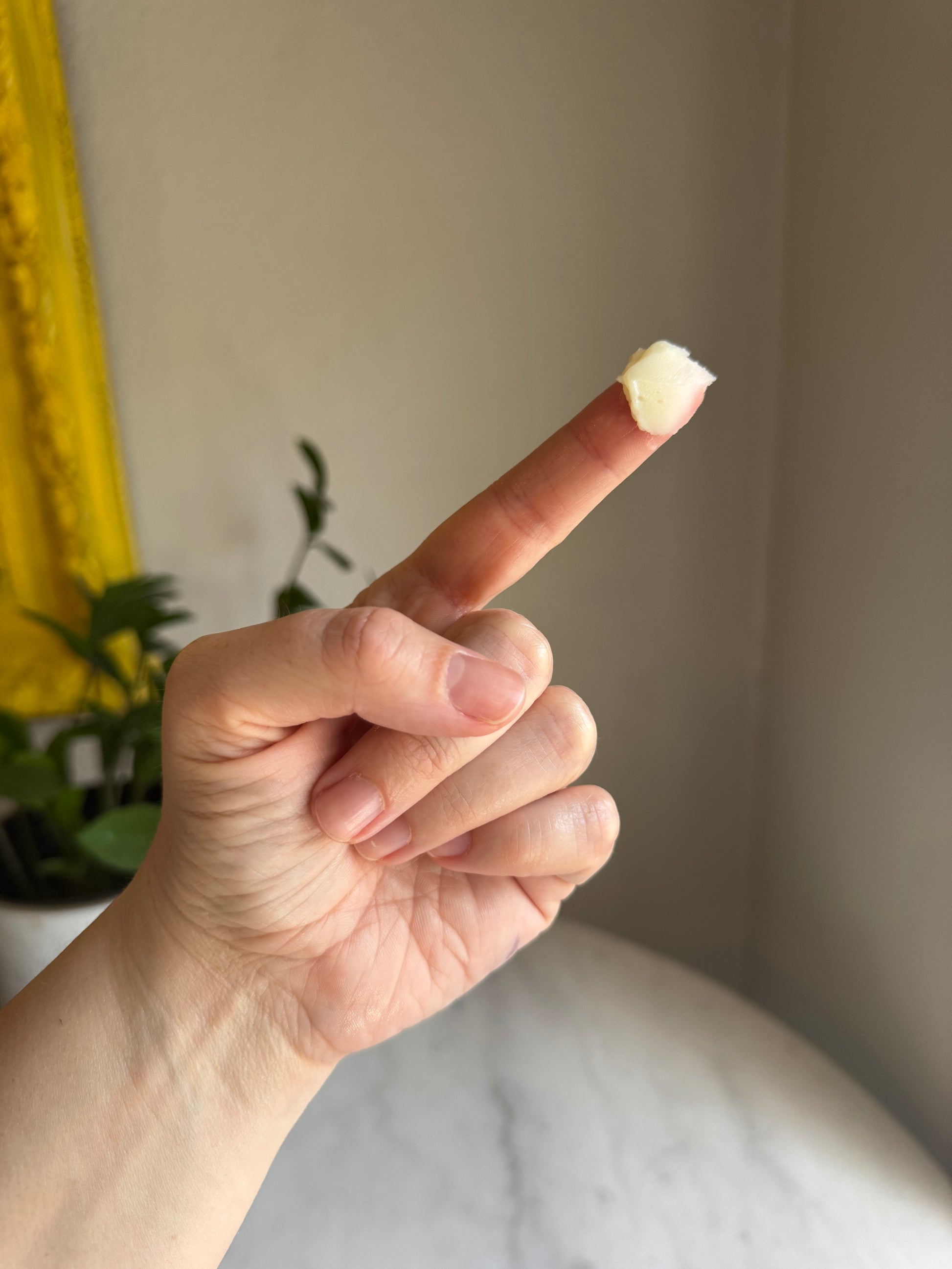 Finger with balm on it