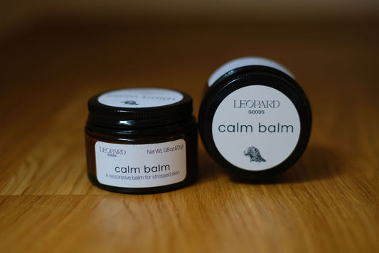 Jar of Calm Balm on a wooden surface